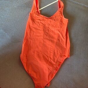 Skims bright orange bodysuit